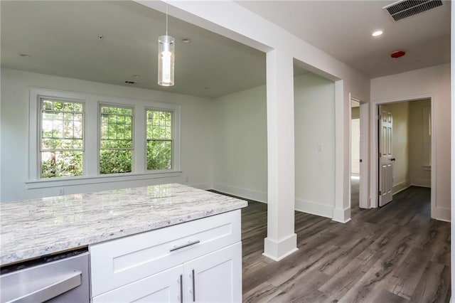 kitchen featuring white cabinets, light stone countertops, hanging light fixtures, and dark hardwood / wood-style flooring