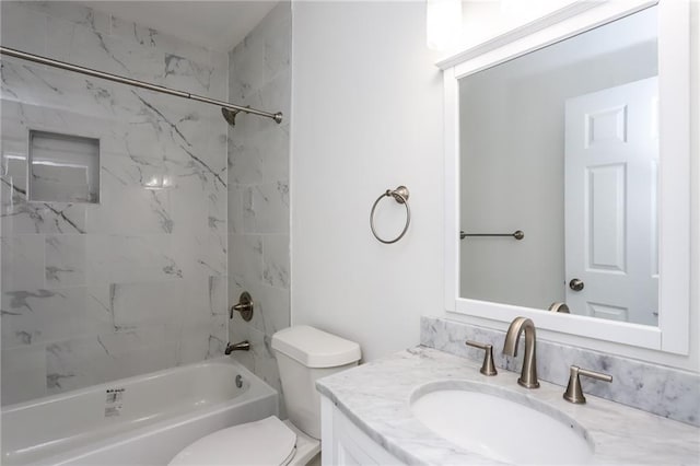 full bathroom with vanity, tiled shower / bath combo, and toilet