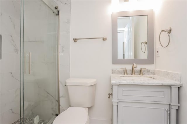 bathroom with toilet, walk in shower, and vanity