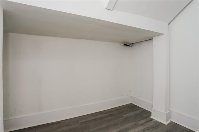 basement featuring dark hardwood / wood-style flooring