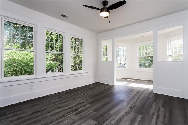 unfurnished sunroom with ceiling fan