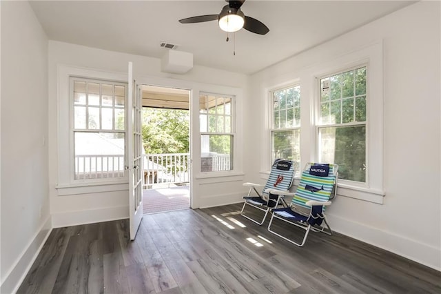 sunroom / solarium featuring a healthy amount of sunlight and ceiling fan