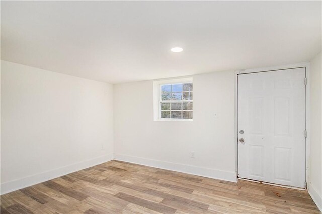 unfurnished room with recessed lighting, light wood-style floors, and baseboards