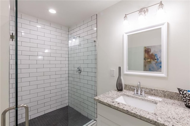 bathroom featuring vanity and a shower stall