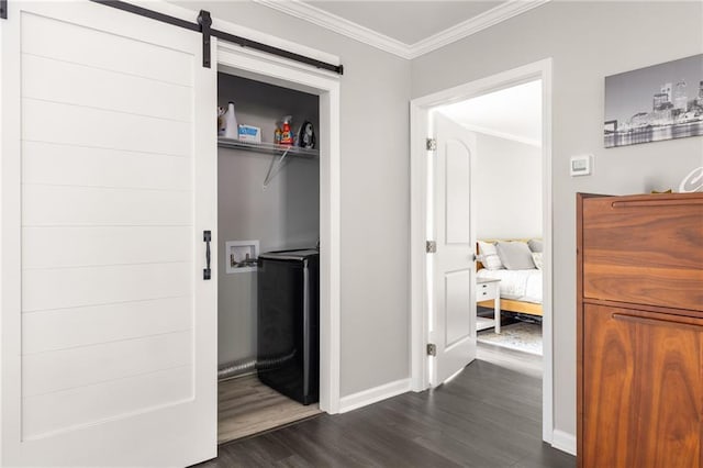 corridor with crown molding, baseboards, dark wood-style flooring, and a barn door