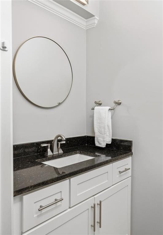 bathroom featuring vanity and ornamental molding