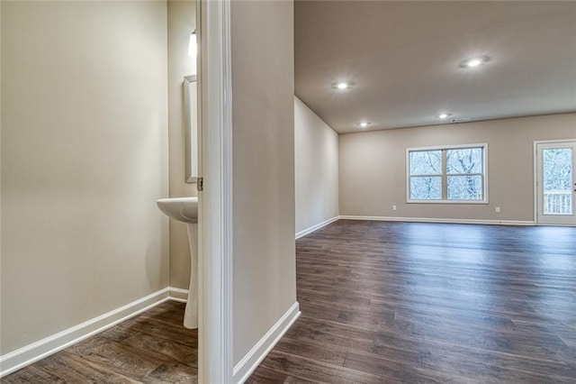 empty room with dark hardwood / wood-style flooring