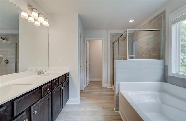 bathroom featuring hardwood / wood-style flooring, vanity, independent shower and bath, and plenty of natural light