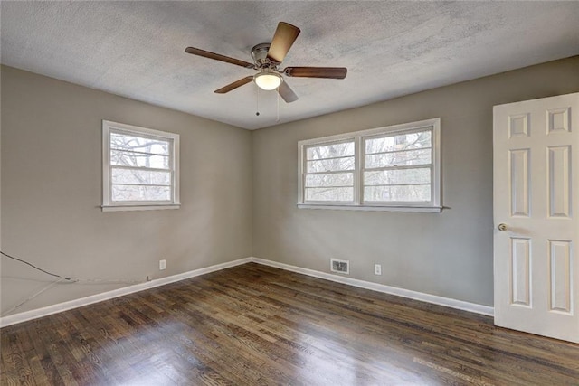 unfurnished room featuring dark hardwood / wood-style floors, ceiling fan, and a textured ceiling