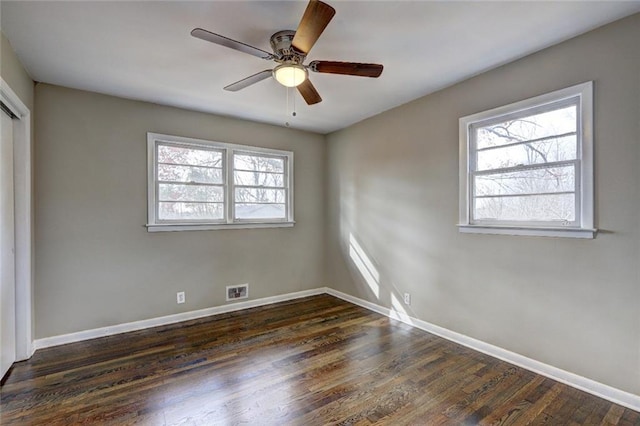 unfurnished bedroom featuring dark hardwood / wood-style floors and ceiling fan