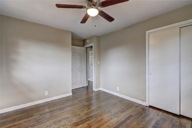 unfurnished bedroom with a closet, ceiling fan, and dark hardwood / wood-style flooring