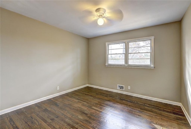 empty room featuring dark hardwood / wood-style flooring and ceiling fan