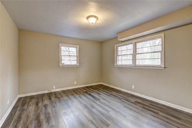 empty room with dark hardwood / wood-style floors