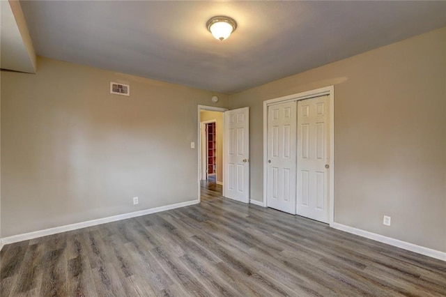 unfurnished bedroom featuring a closet and wood-type flooring