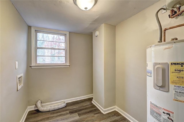 laundry area featuring electric water heater and dark wood-type flooring