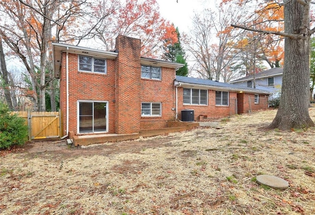 back of house with central AC unit