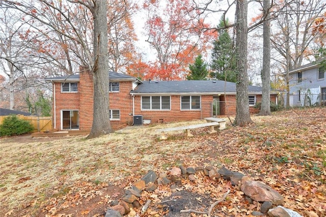 rear view of house with central AC unit