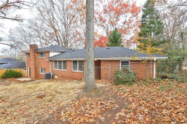 back of house with central AC unit