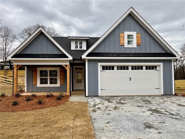 view of front of home featuring aphalt driveway, covered porch, board and batten siding, a standing seam roof, and metal roof