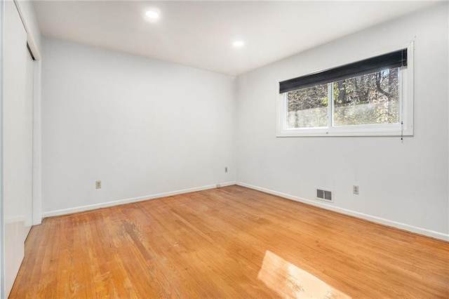 spare room with recessed lighting, baseboards, visible vents, and light wood finished floors