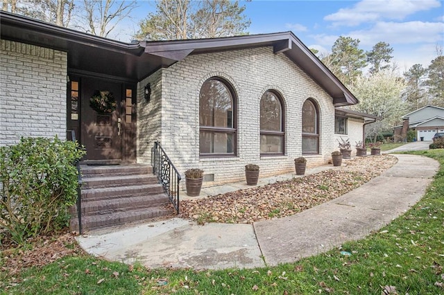 view of property exterior featuring brick siding