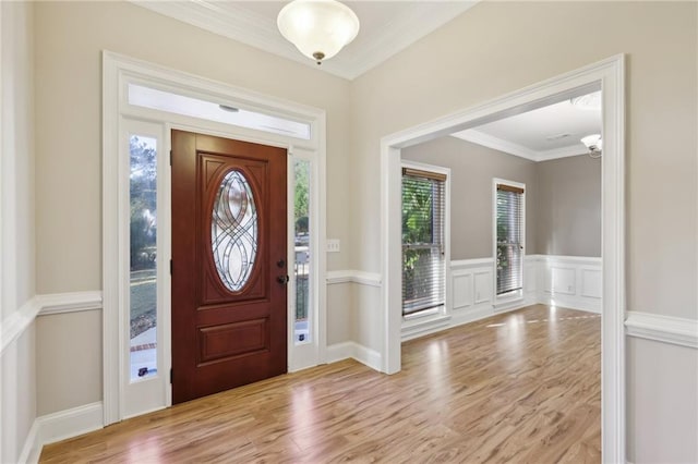 entrance foyer featuring light hardwood / wood-style flooring and crown molding