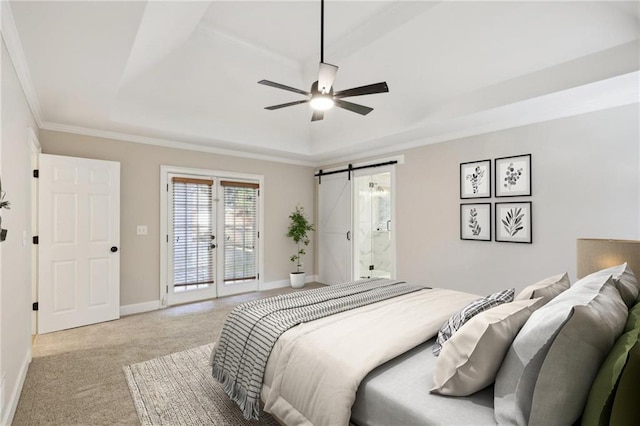 carpeted empty room featuring french doors, a raised ceiling, crown molding, ceiling fan, and a barn door