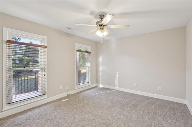 carpeted empty room featuring ceiling fan