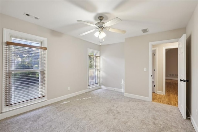 empty room featuring carpet floors and ceiling fan