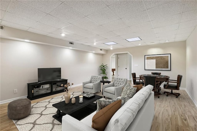 empty room featuring a paneled ceiling and light hardwood / wood-style flooring