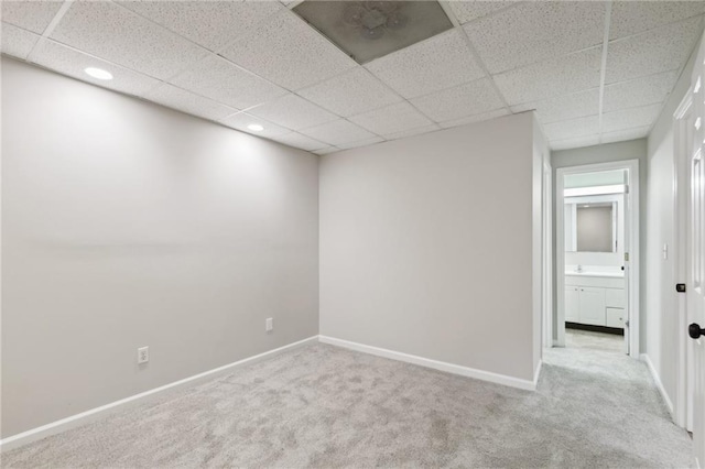 spare room featuring carpet floors and a paneled ceiling