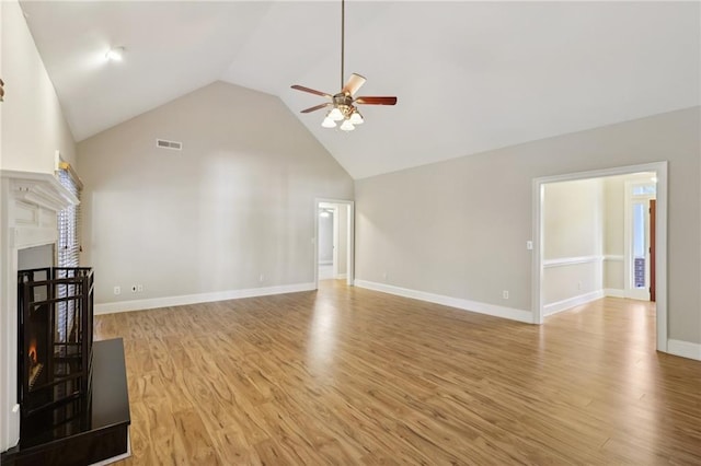 unfurnished living room featuring ceiling fan, light hardwood / wood-style floors, and high vaulted ceiling