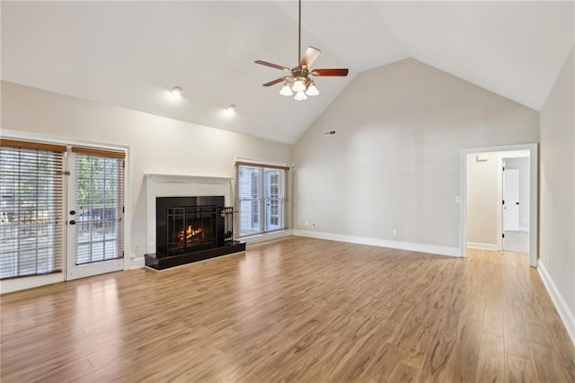 unfurnished living room with ceiling fan, light hardwood / wood-style flooring, and high vaulted ceiling