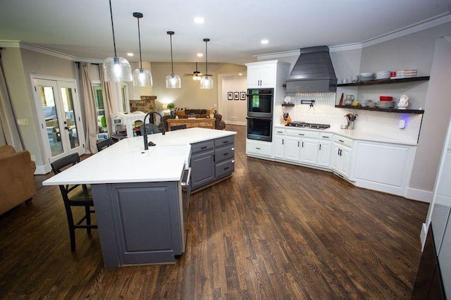200 Carney Ct, Ball Ground, GA 30107 - kitchen featuring dobule oven black, decorative backsplash, a kitchen island with sink, custom exhaust hood, and open floor plan