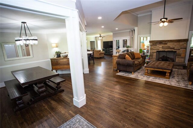 200 Carney Ct, Ball Ground, GA 30107 - living area featuring ornamental molding, wood finished floors, a stone fireplace, baseboards, and ceiling fan with notable chandelier