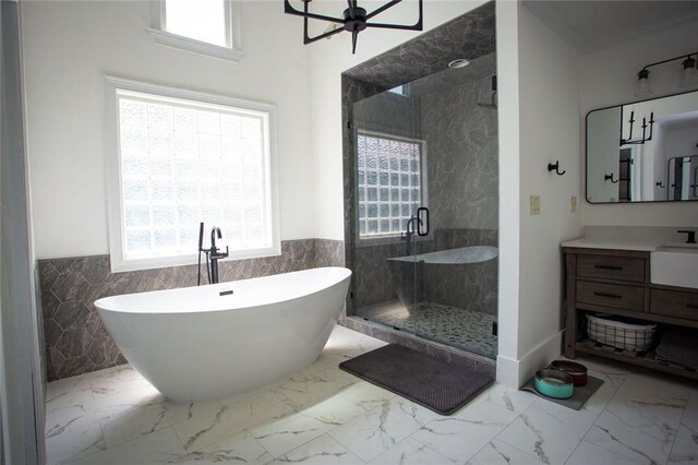 200 Carney Ct, Ball Ground, GA 30107 - full bathroom with wainscoting, tile walls, a stall shower, and a freestanding bath