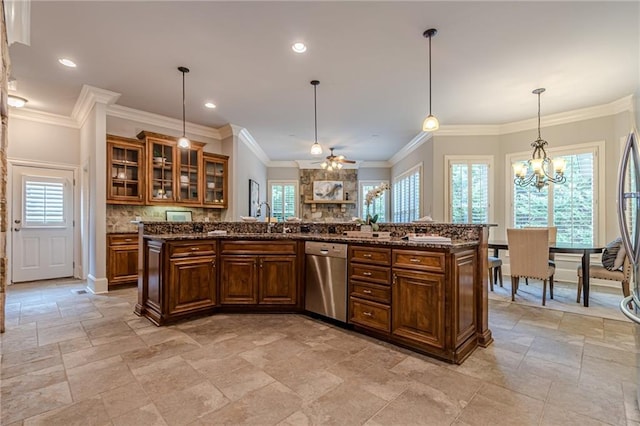 kitchen with hanging light fixtures, dishwasher, a kitchen island, and a wealth of natural light