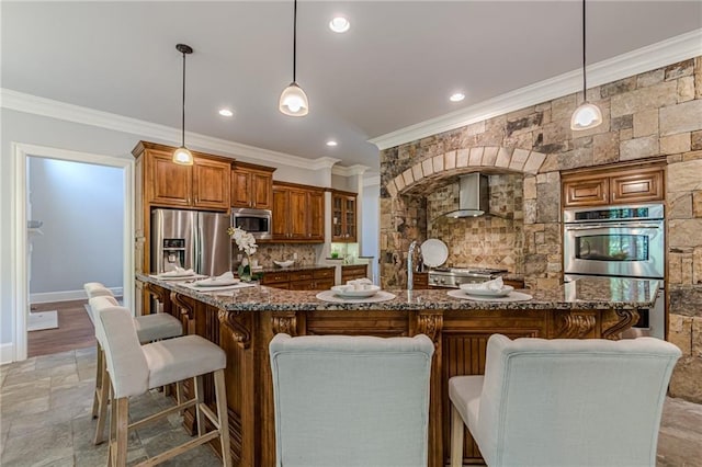 kitchen with appliances with stainless steel finishes, decorative light fixtures, a breakfast bar, and backsplash