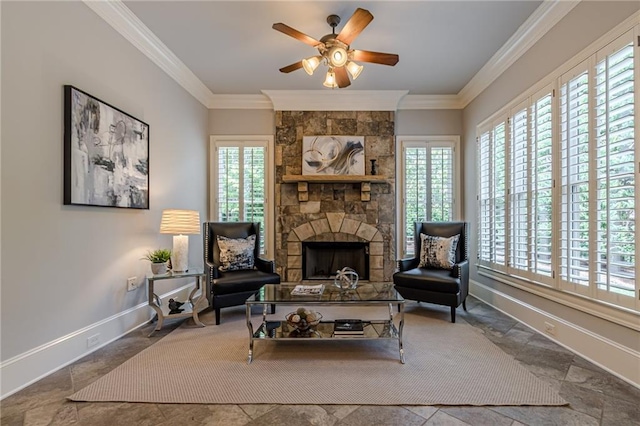 sitting room featuring ornamental molding, ceiling fan, and a fireplace