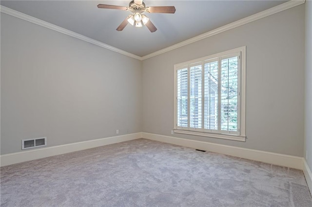 empty room featuring crown molding, ceiling fan, and carpet flooring