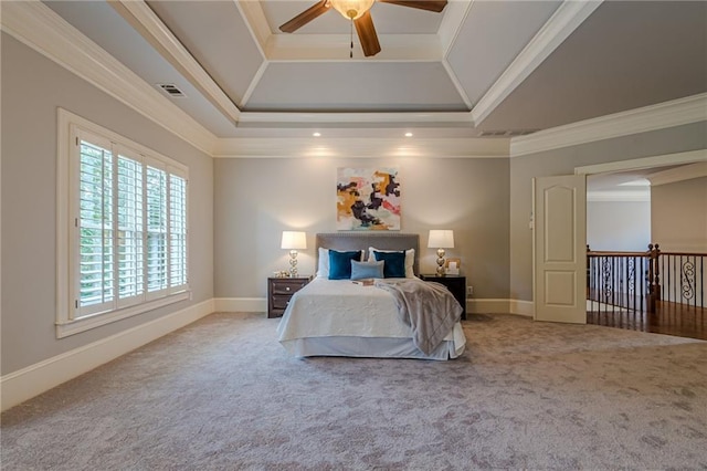 bedroom featuring ceiling fan, carpet floors, ornamental molding, vaulted ceiling, and a raised ceiling