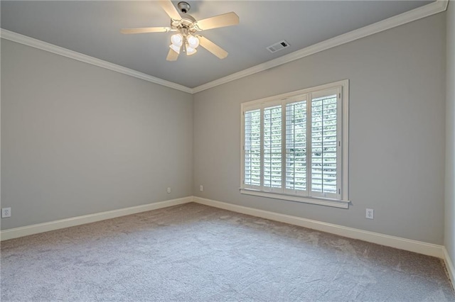 empty room with ornamental molding, ceiling fan, and carpet flooring