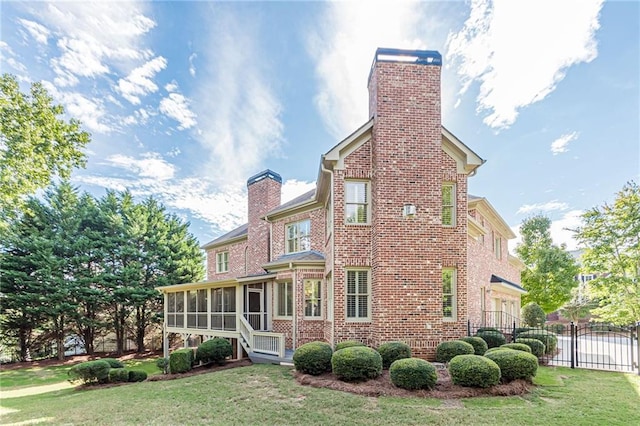 exterior space featuring a yard and a sunroom