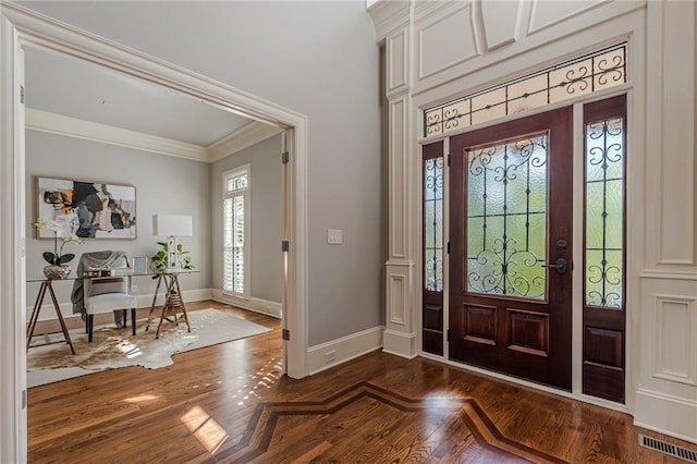 entryway featuring crown molding and dark hardwood / wood-style floors