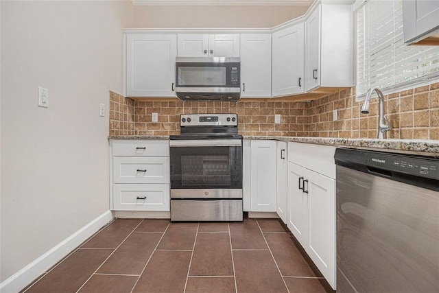 kitchen featuring stone counters, sink, white cabinets, backsplash, and stainless steel appliances