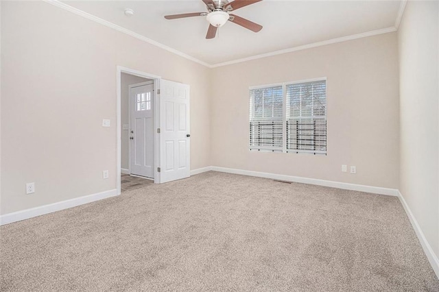 carpeted empty room with ornamental molding and ceiling fan