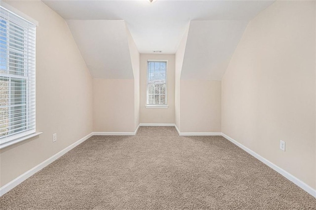 bonus room featuring carpet floors and vaulted ceiling