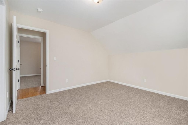 bonus room featuring lofted ceiling and carpet flooring