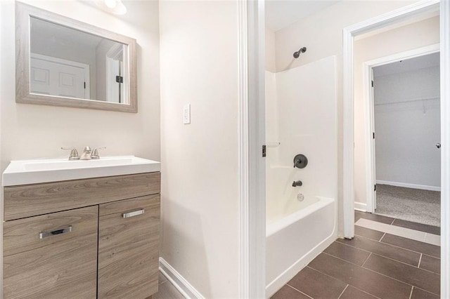 bathroom with washtub / shower combination and vanity