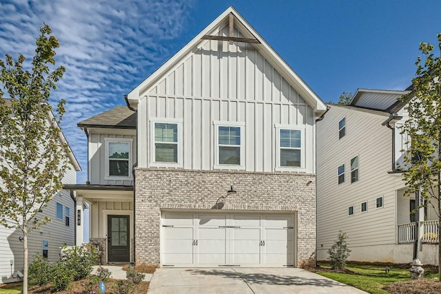 view of front of property with brick siding, board and batten siding, concrete driveway, and an attached garage